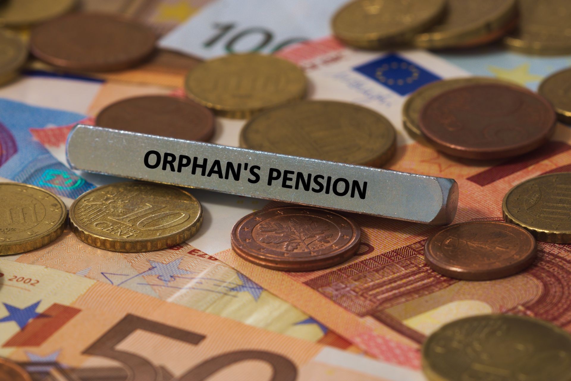 orphan's pension - the word was printed on a metal bar. the metal bar was placed on several banknotes